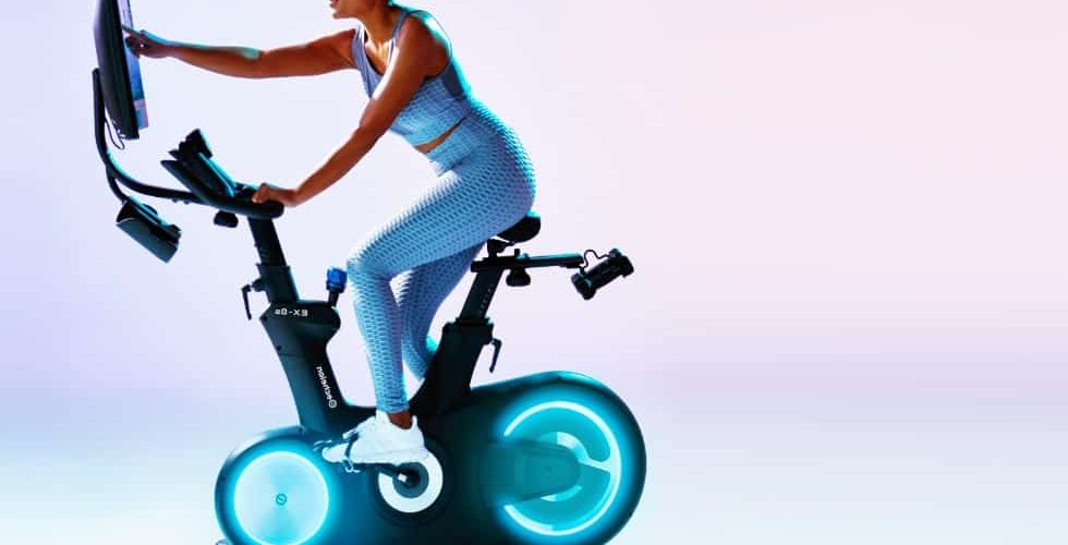 a woman selects a workout on the new EX-8s